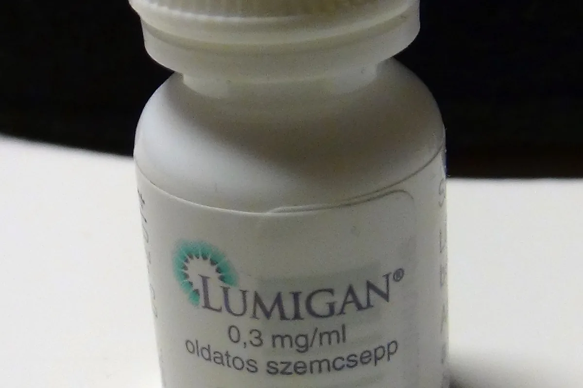 A small white dropper bottle of Lumigan bimatoprost 0.3 mg/ml eye drops