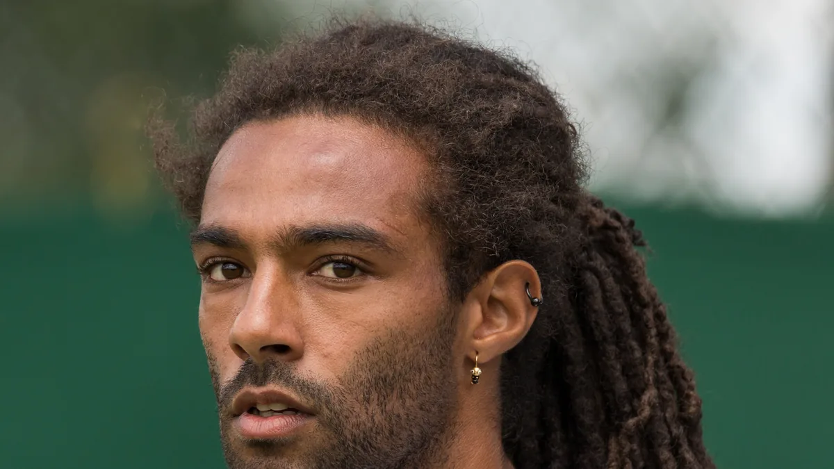 Homme aux longues dreadlocks attachées dans le dos