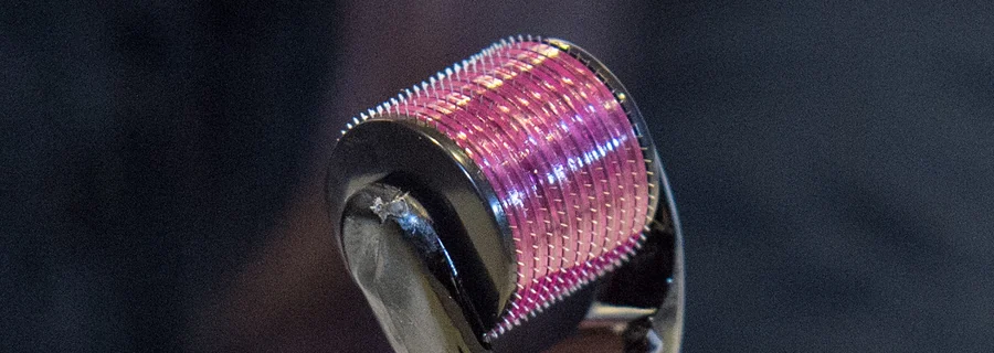 Close-up of a derma roller, a small drum covered in rows of fine needles