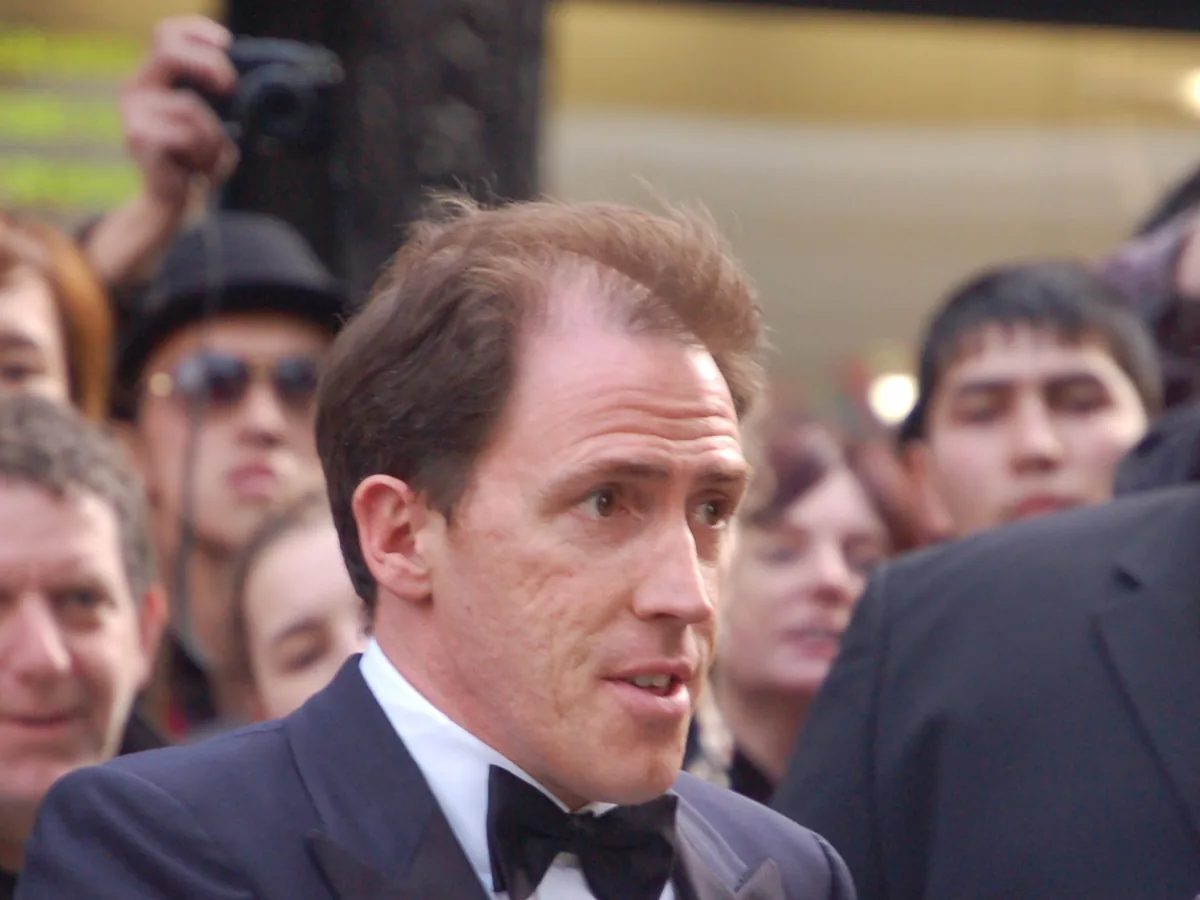 Rob Brydon at the BAFTA awards in London in 2008, with his hair short and swept back and the temples visibly higher than the centre of the hairline