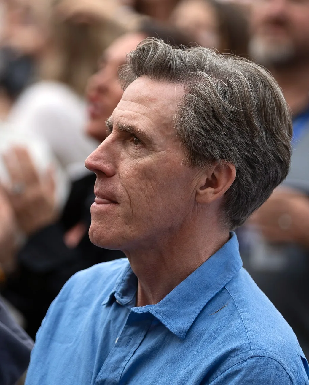 Side view of Rob Brydon in 2025 with grey hair brushed forward and to the side over the temple