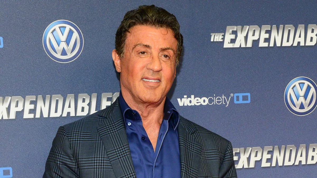 Sylvester Stallone at the Expendables 3 premiere in Cologne in 2014, with short dark hair combed back from the forehead