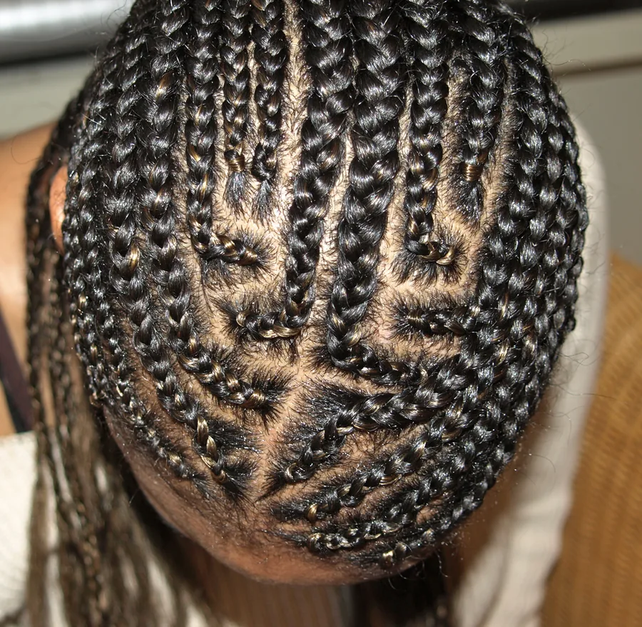 Top of a head with tight cornrows braided from the front hairline